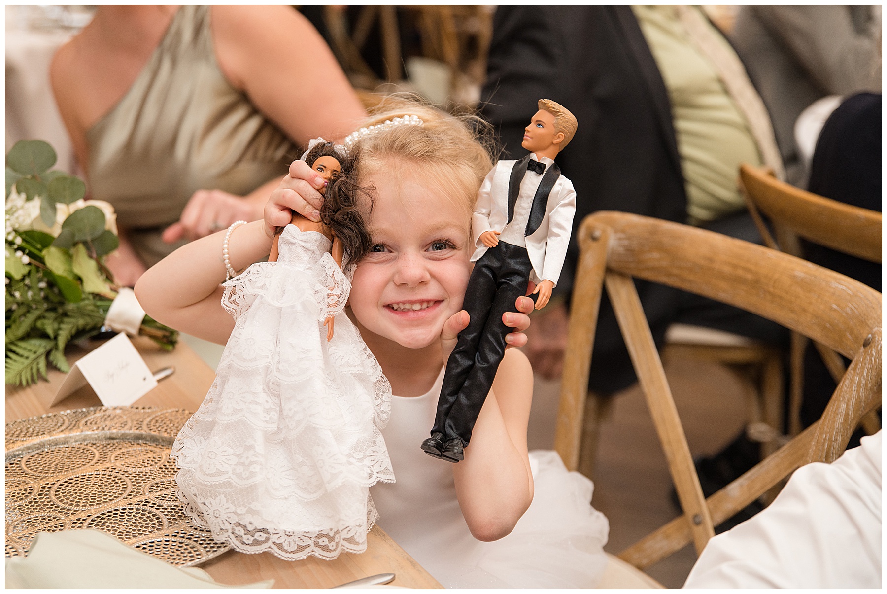 flower girl smiling with bride and groom barbies