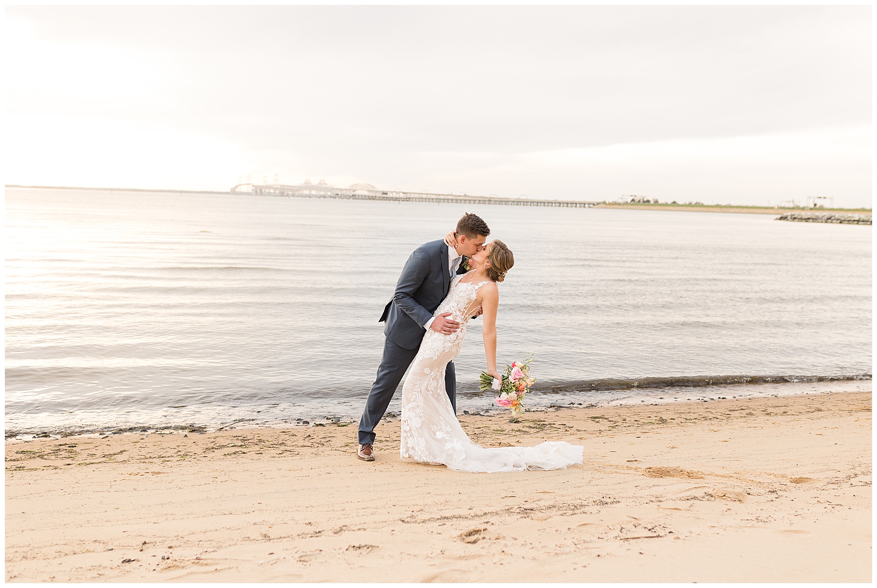 couple portrait on the beach dip kiss