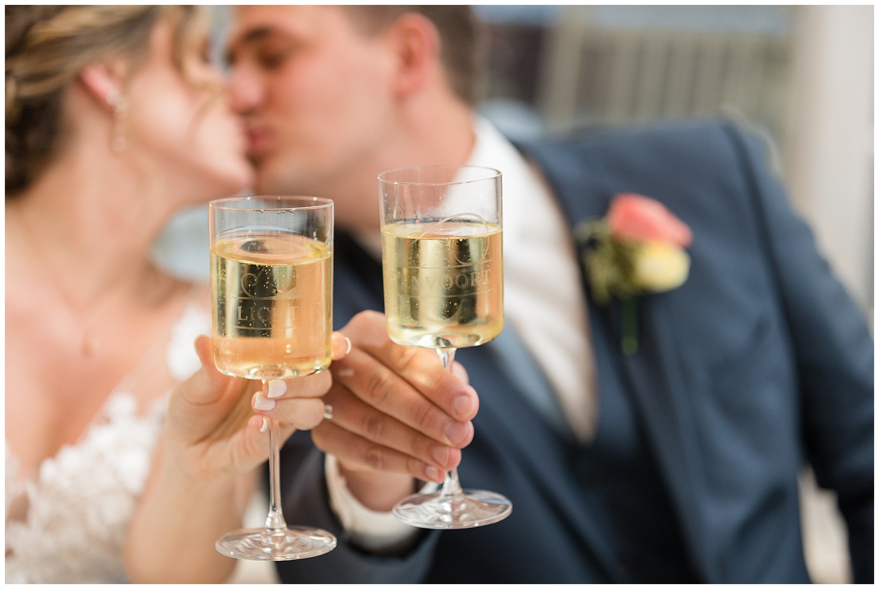 bride and groom toast and kiss