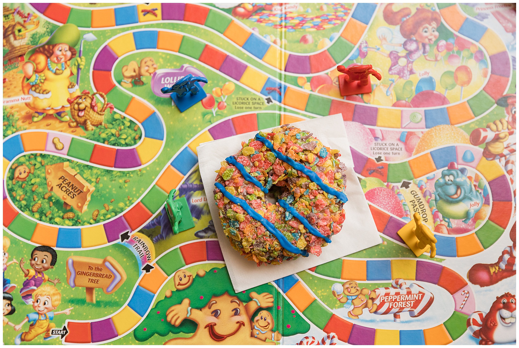 fruity pebble donut on candyland board