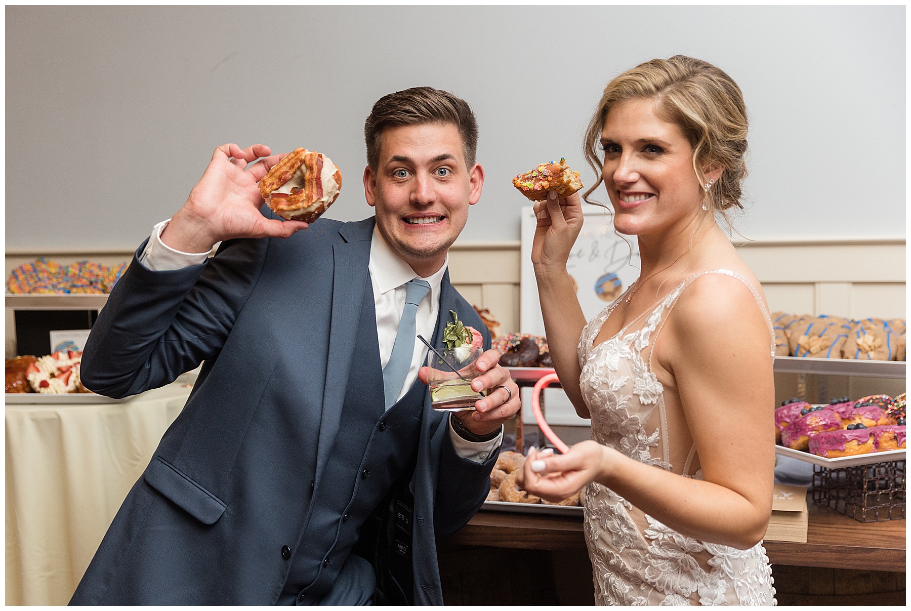 bride and groom share donut