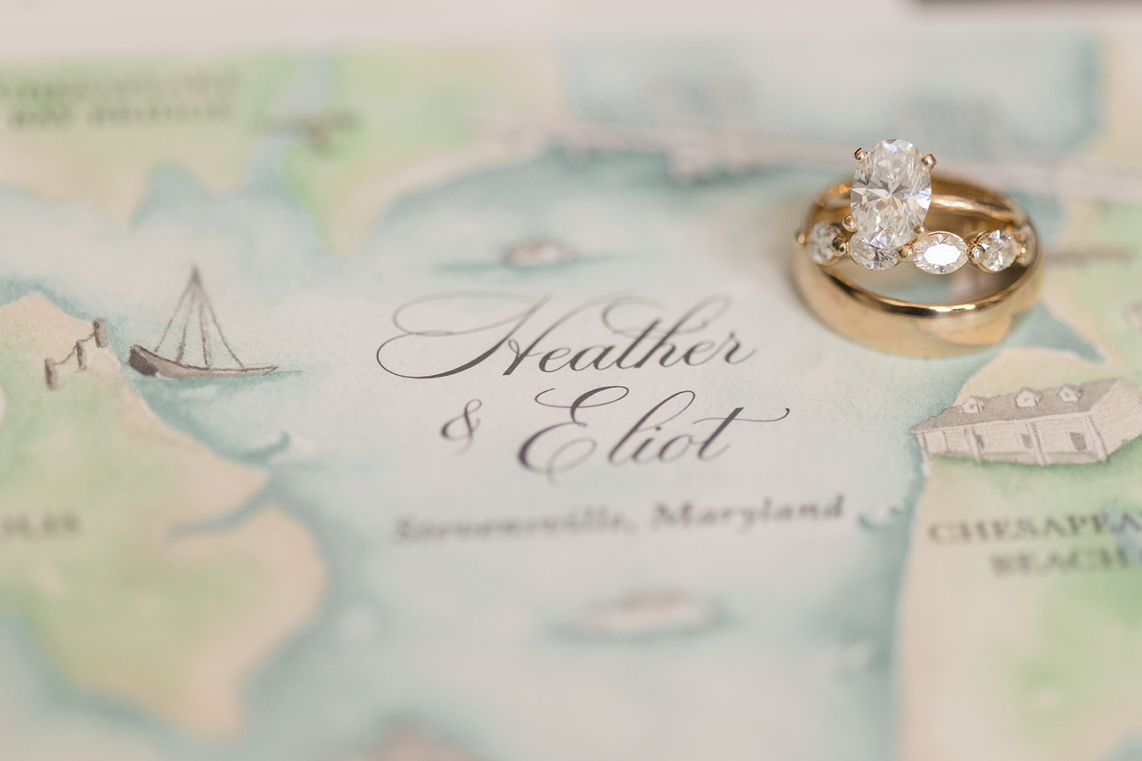 close up of wedding invitation and wedding rings