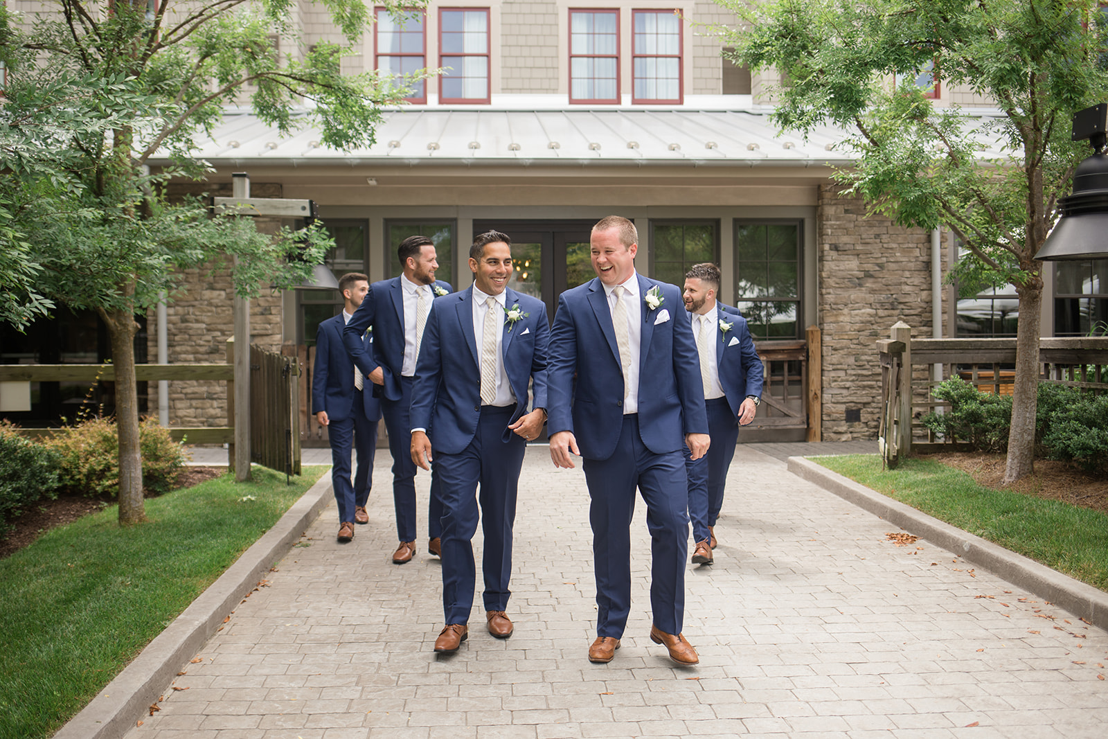 groom and groomsmen walking at chesapeake bay beach club inn