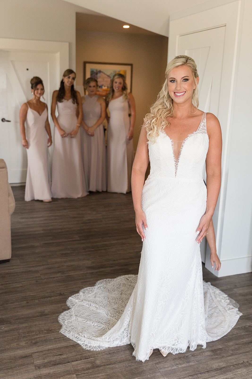 bride reveal with bridesmaids behind her