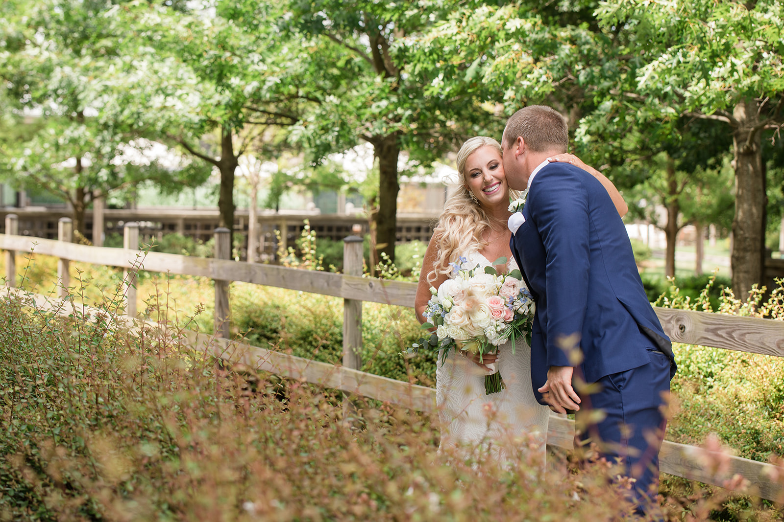 groom kissing bride on cheek