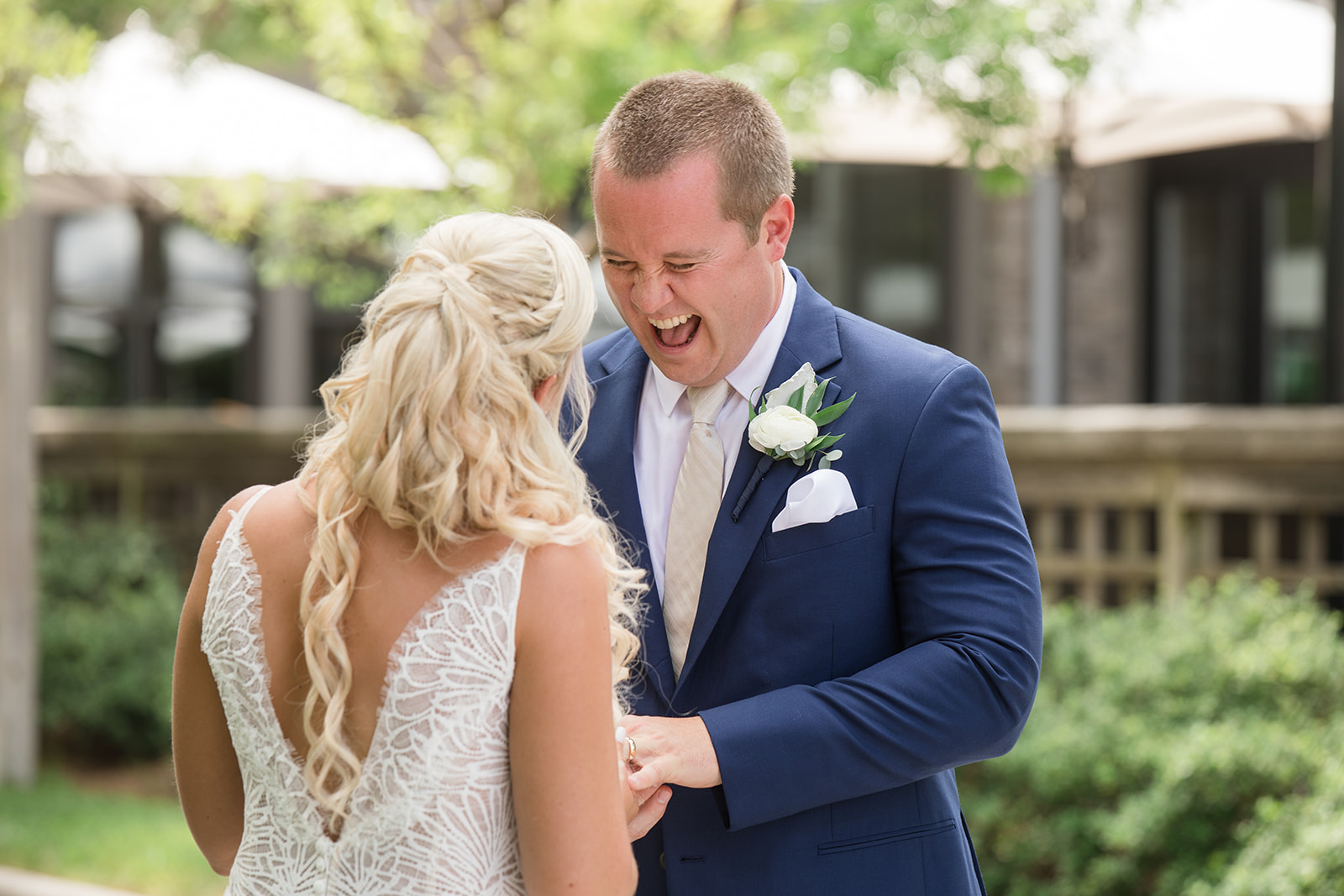 groom laughing and checking out his bride