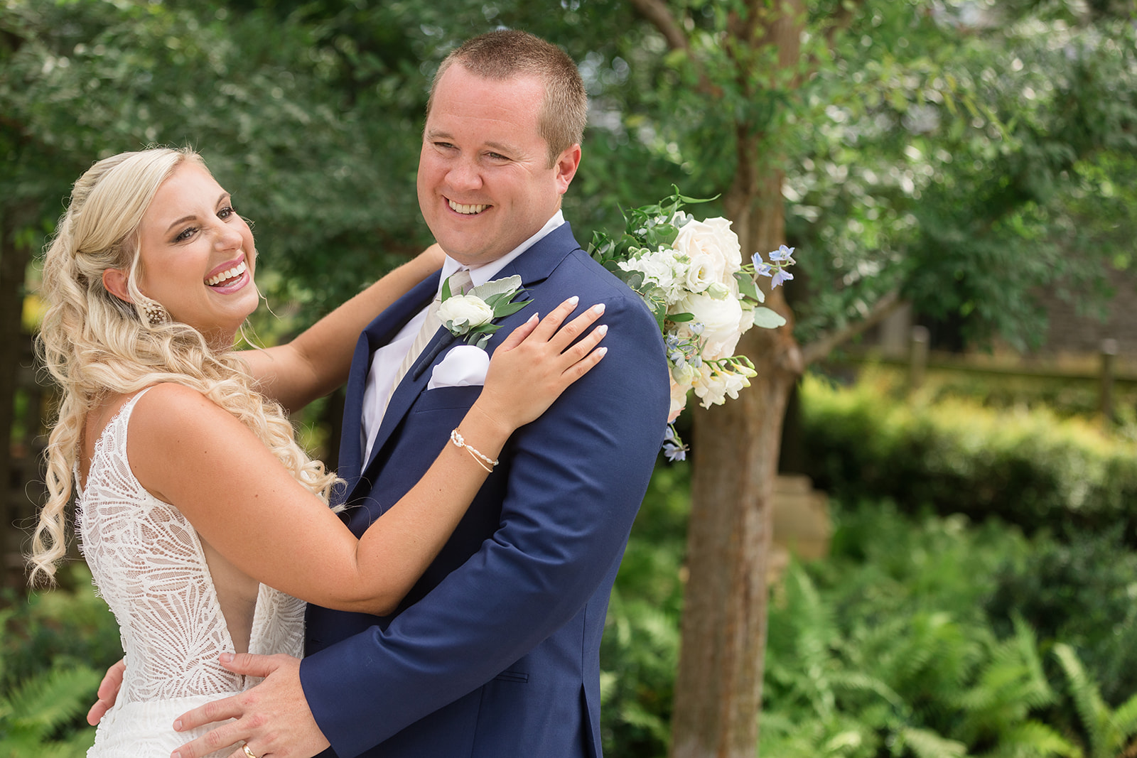 bride and groom embrace and smile