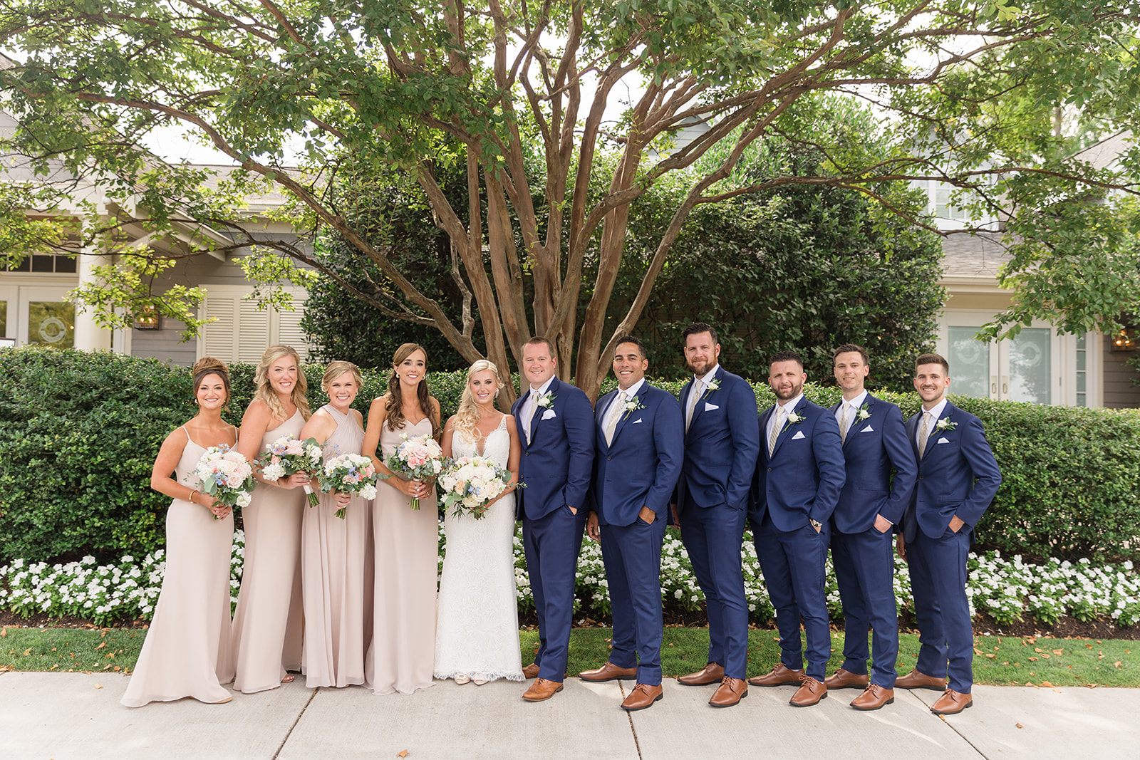 full wedding party lined up smiling at camera