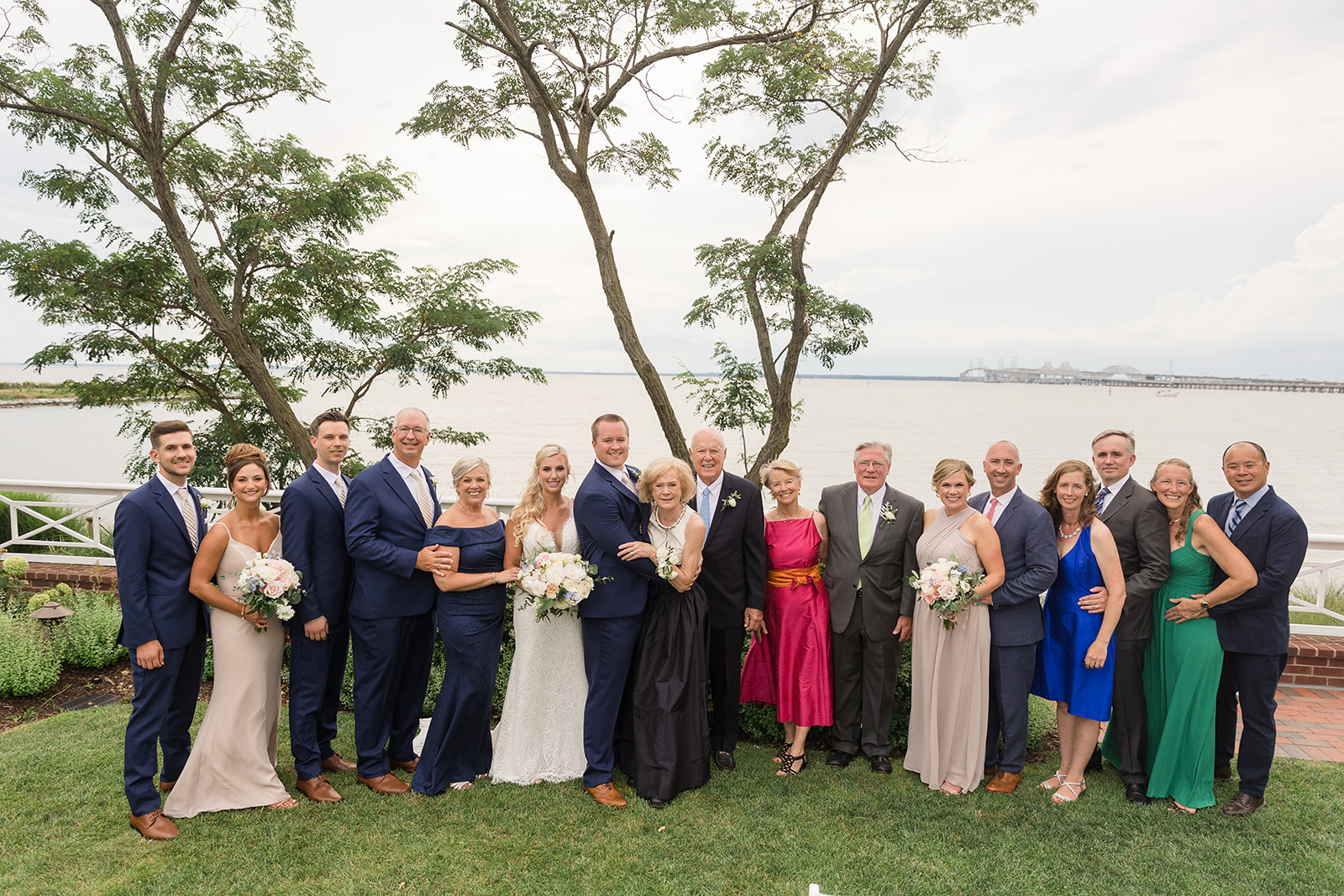 big family photo in front of chesapeake bay