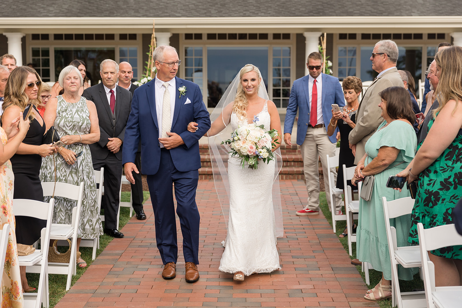 bride and her dad walk down the aisle