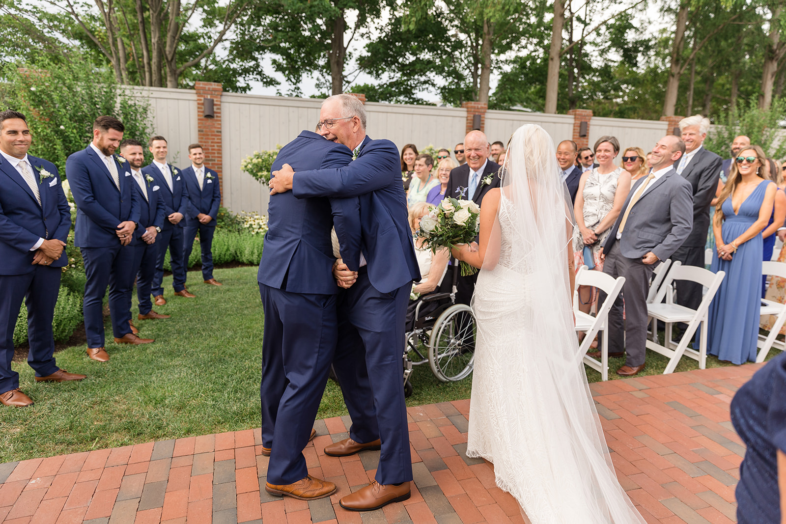 groom hugging bride's dad