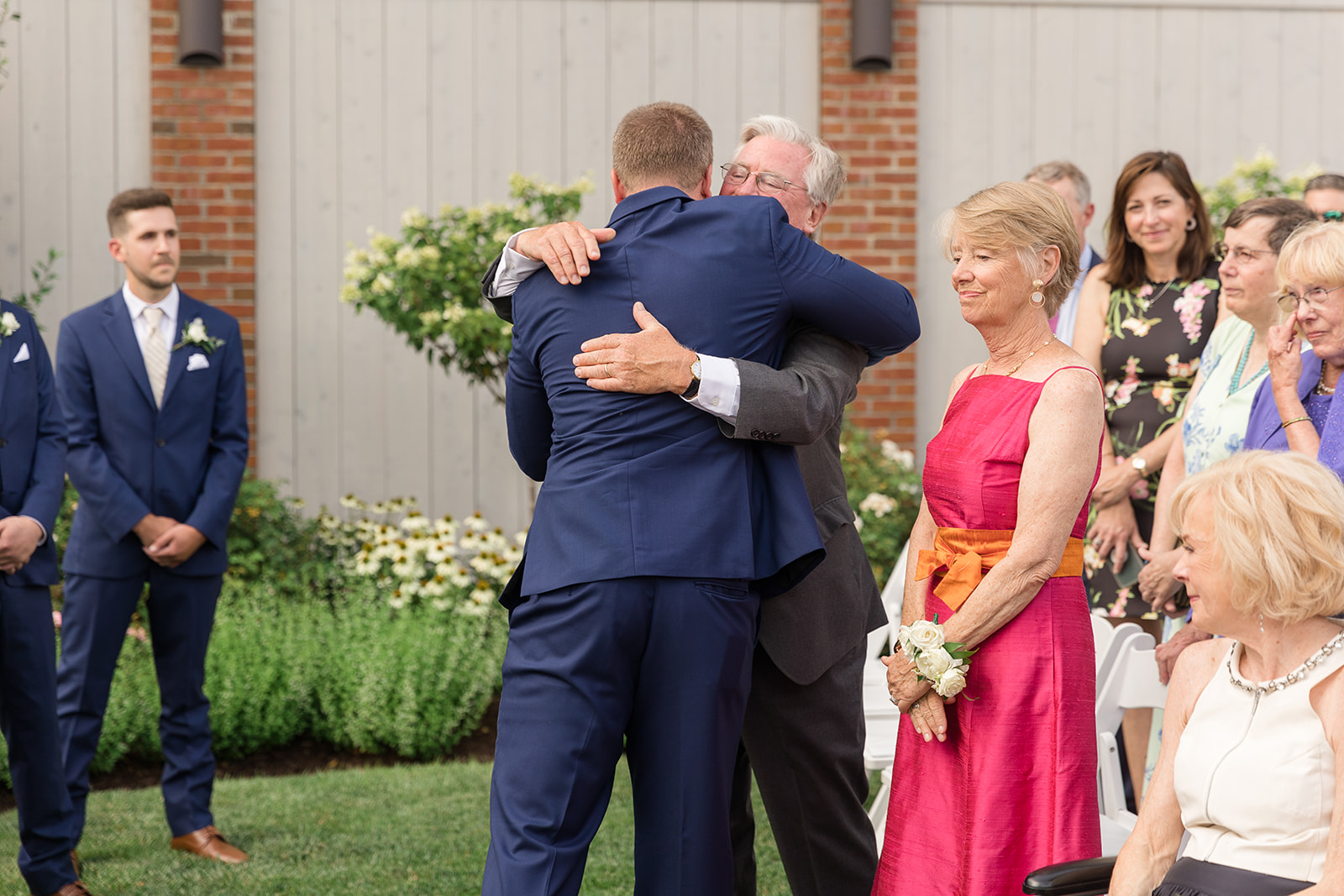 groom hugging bride's dad