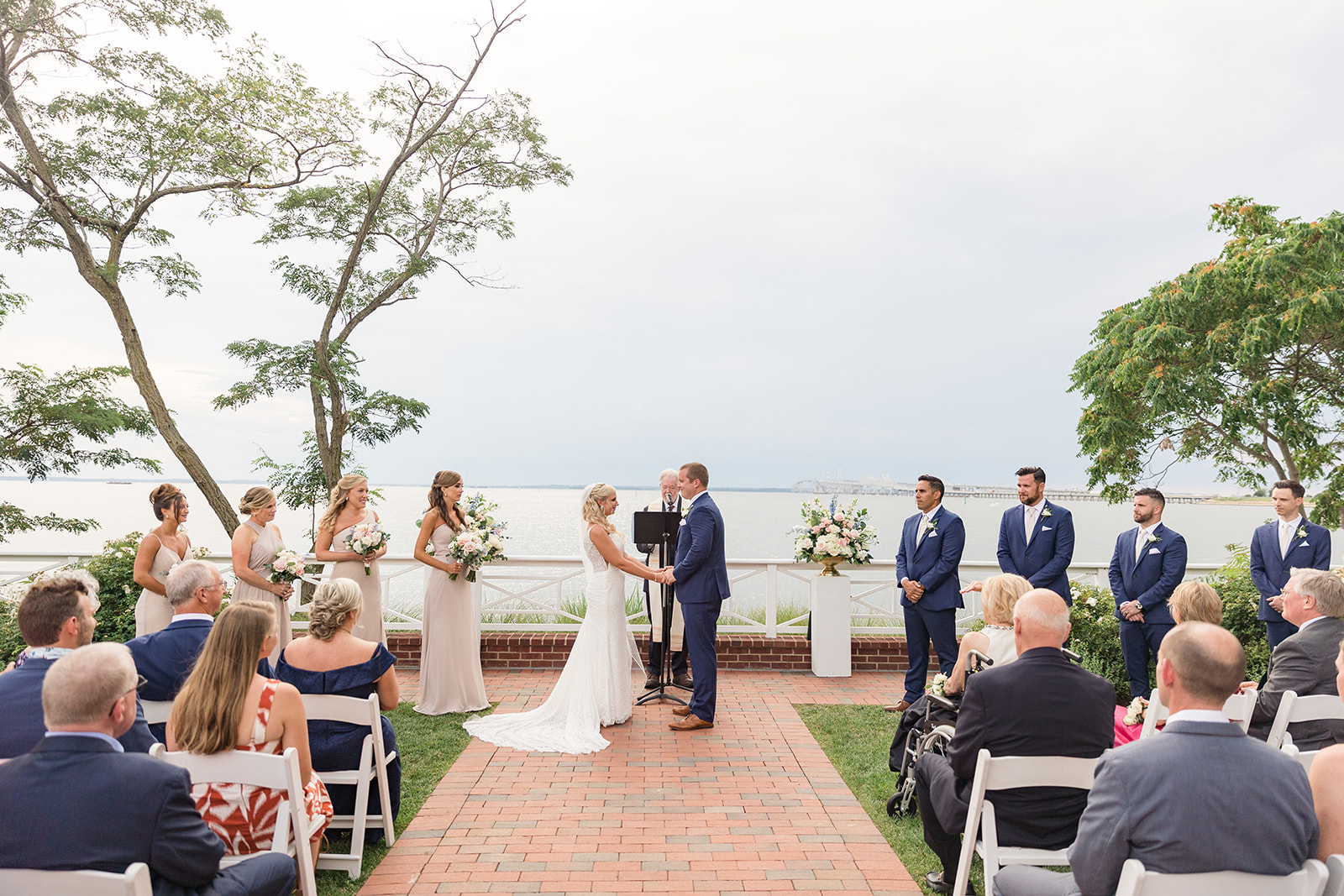 bride and groom hold hands during ceremony