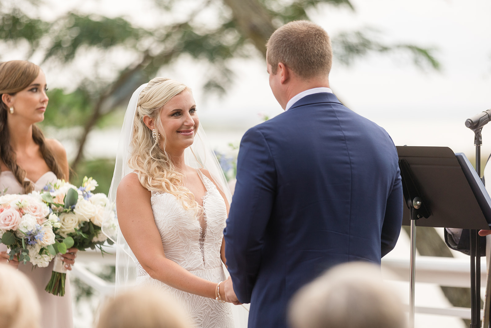 bride smiles at groom during wedding ceremony