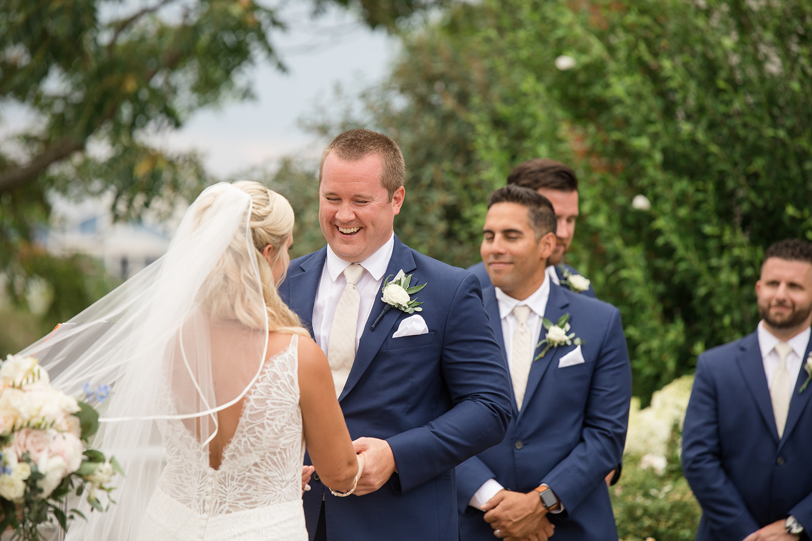 groom laughs during wedding ceremony