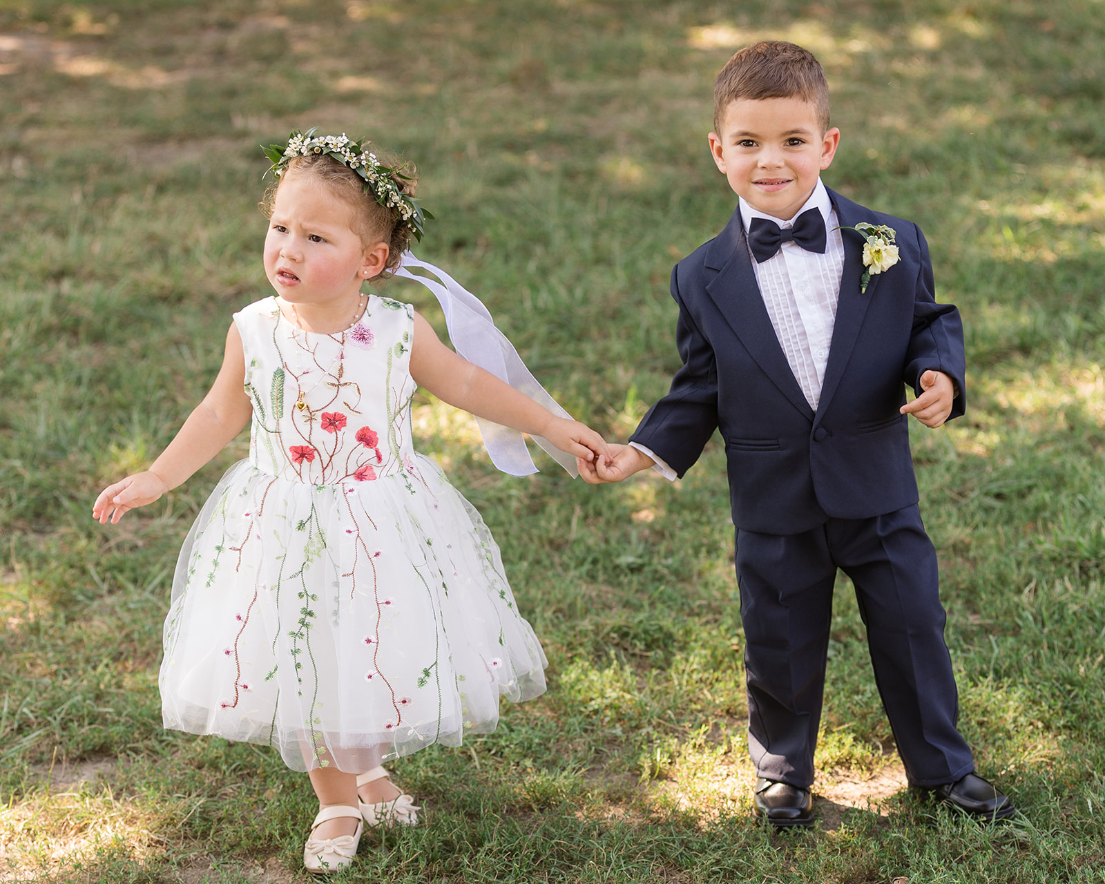 flower girl and ring bearer walking holding hands