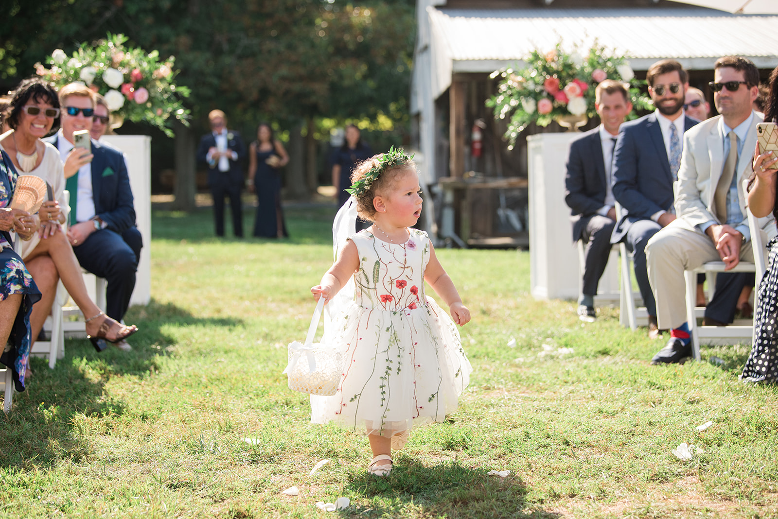 flower girl coming down wedding aisle