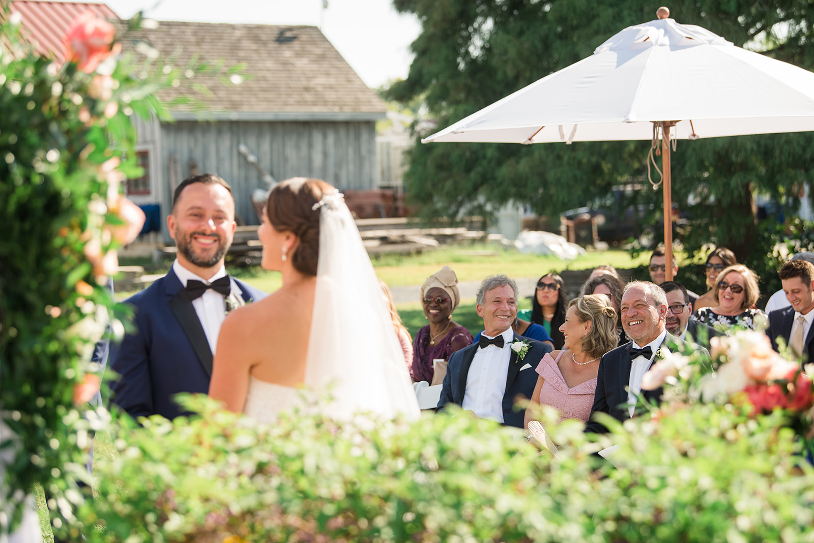 bride and groom during wedding ceremony with guests in the background