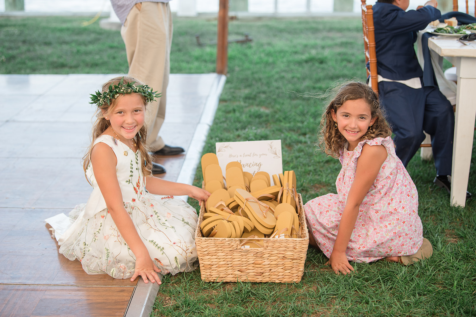 young girls posing with flip flop basket at wedding reception