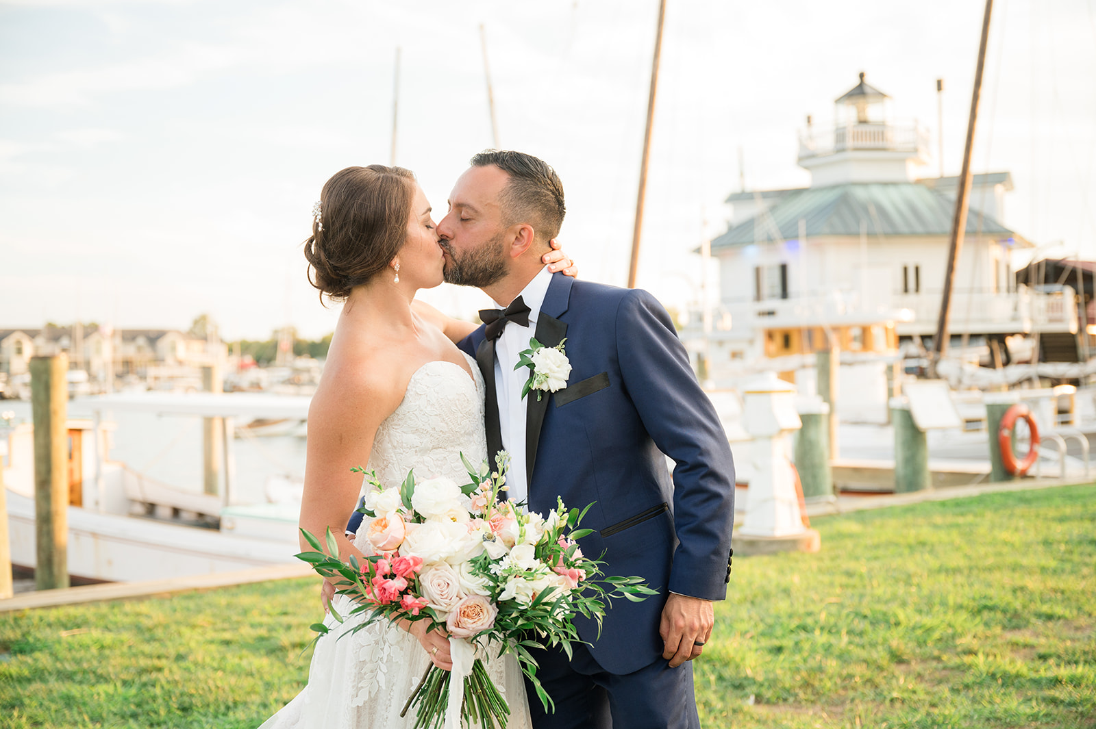 bride and groom kissing during sunset portraits