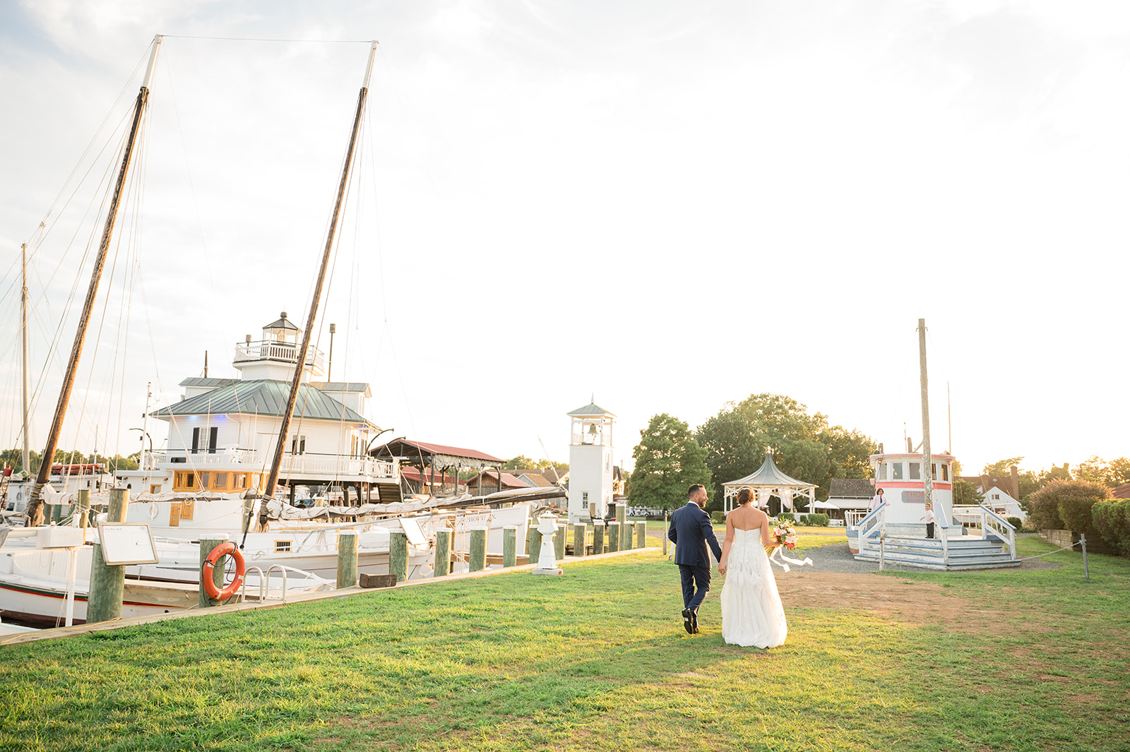 bride and groom walking away from camera during sunset portraits