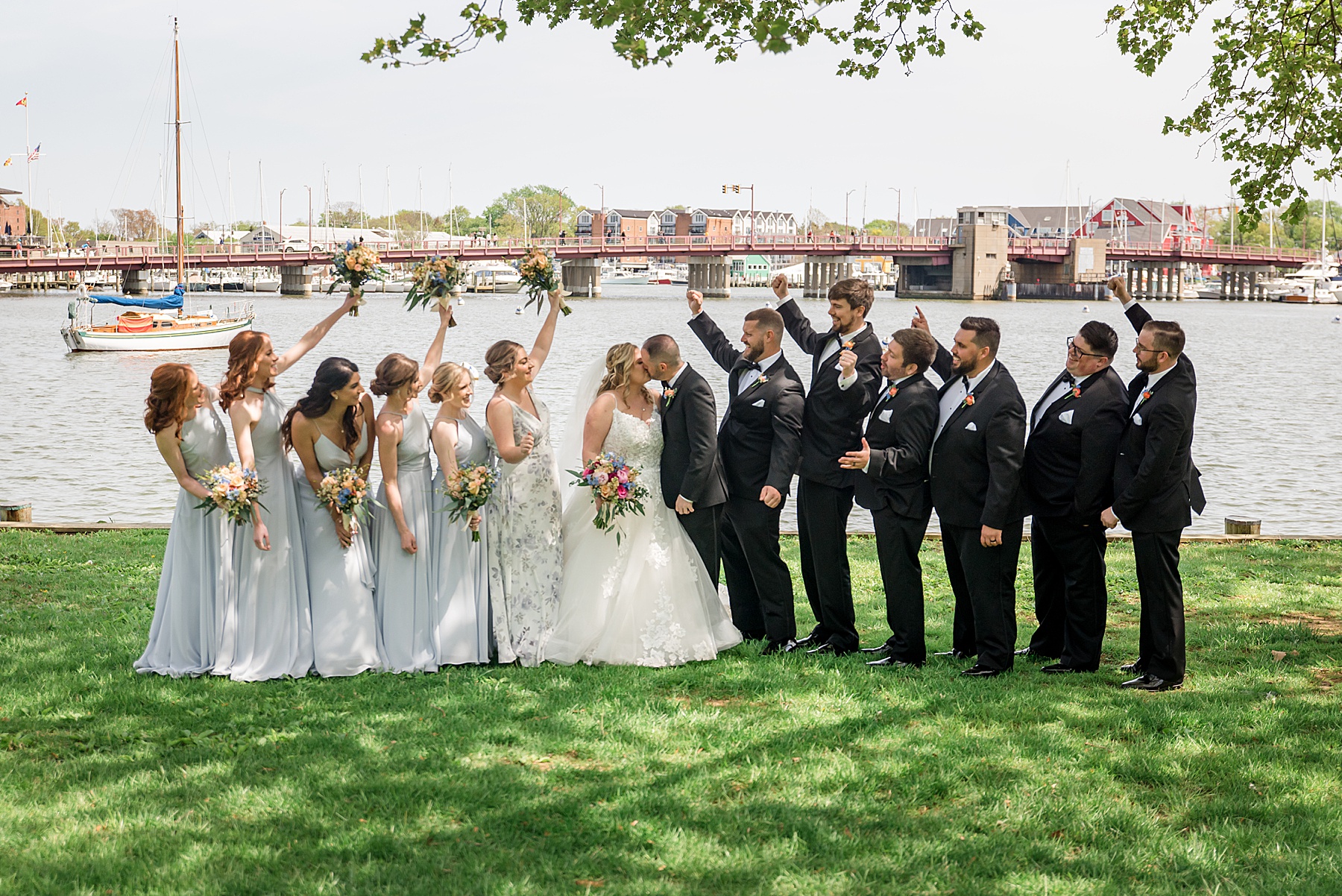 wedding party cheering bride and groom kiss