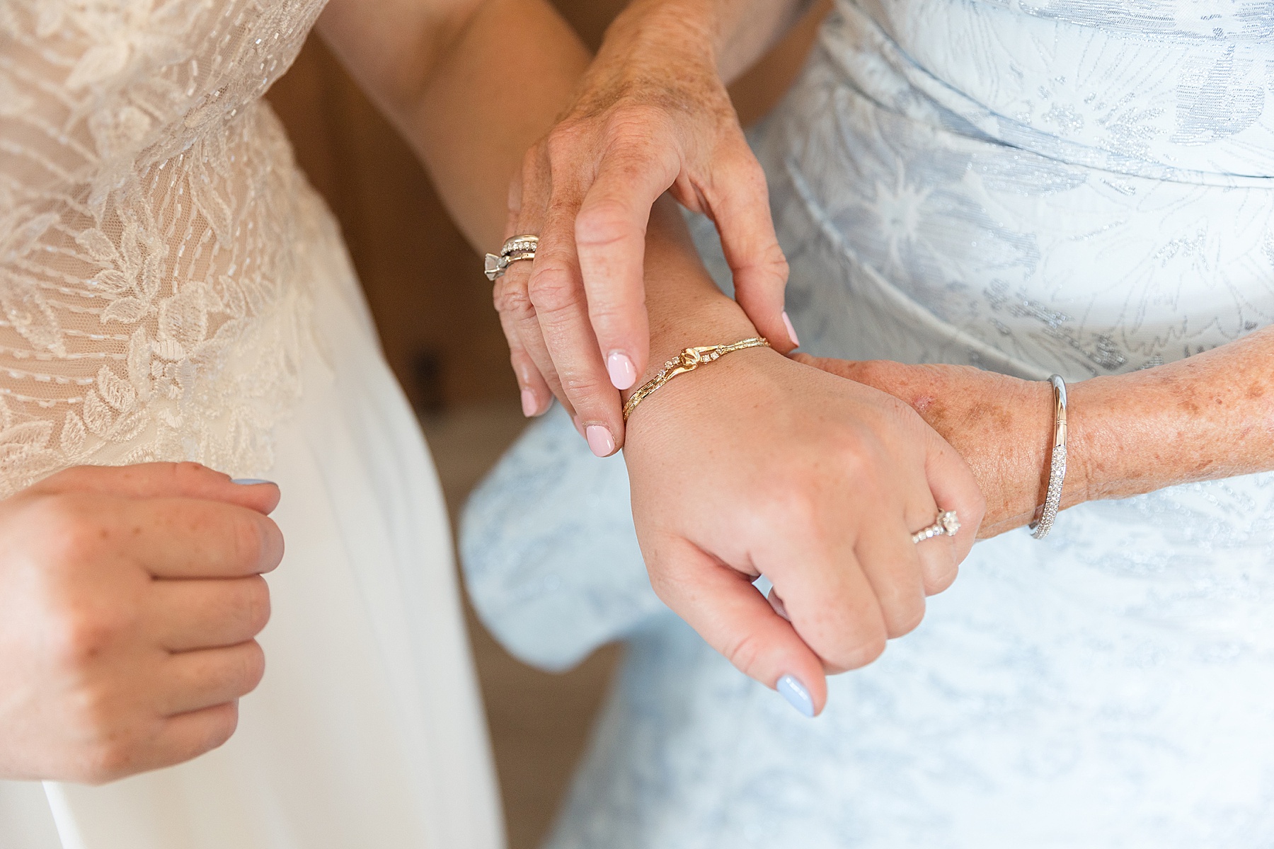 bride getting ready mom puts on bracelet