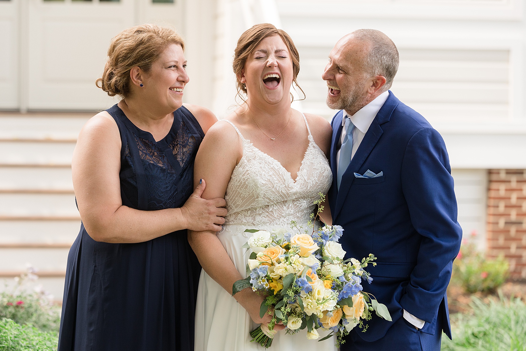 bride laughing with parents