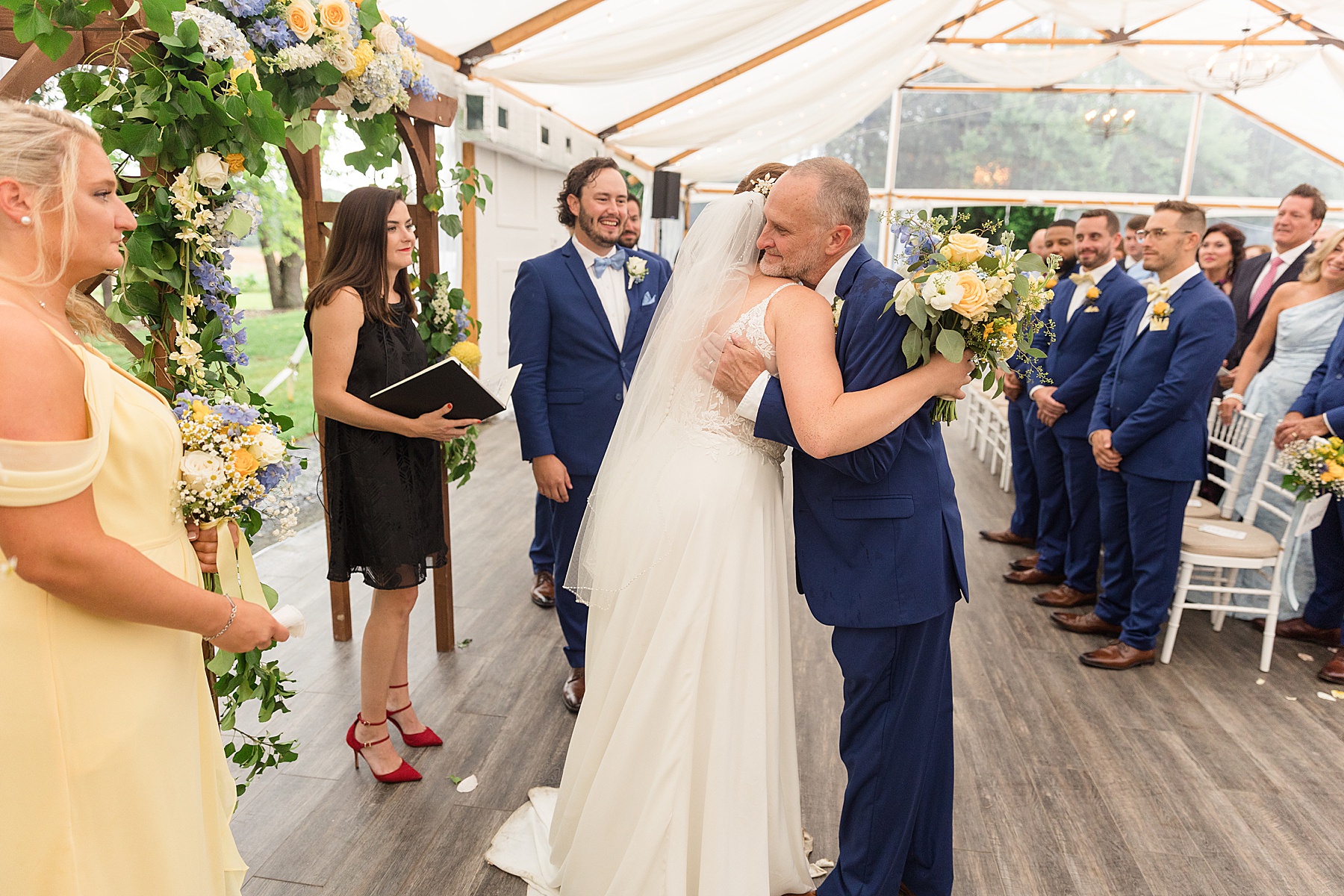 bride hugs dad wedding ceremony