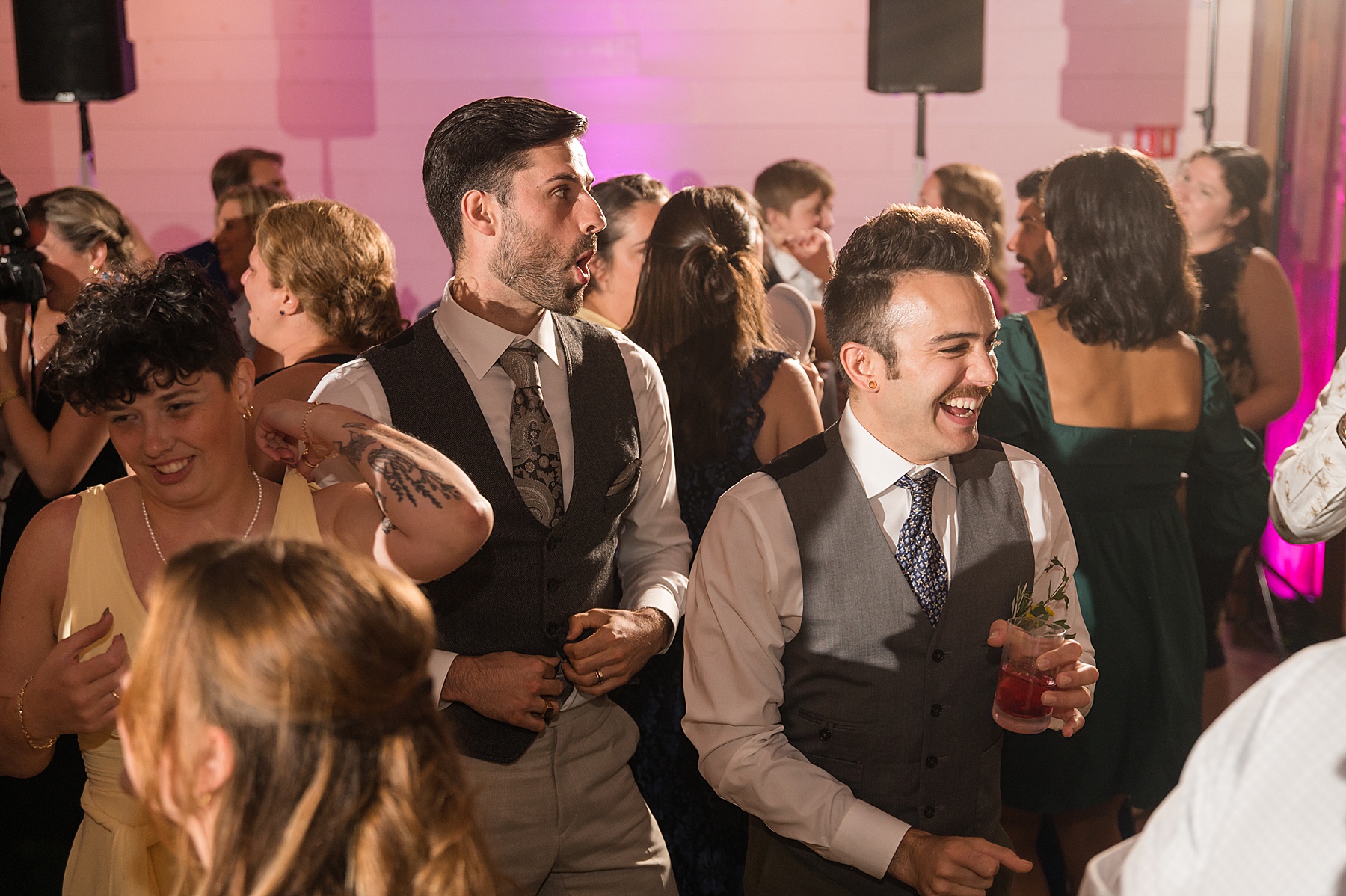 candid wedding guests dancing