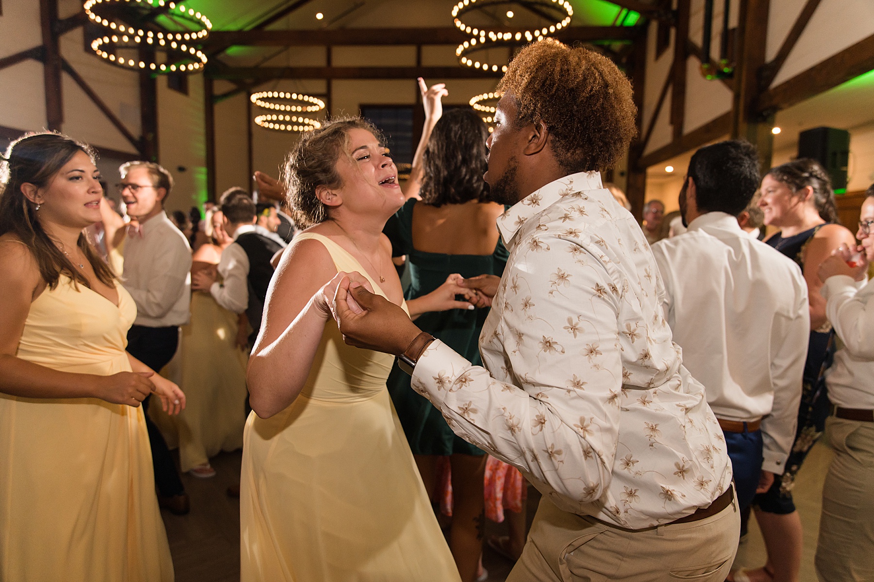 candid wedding guests dancing