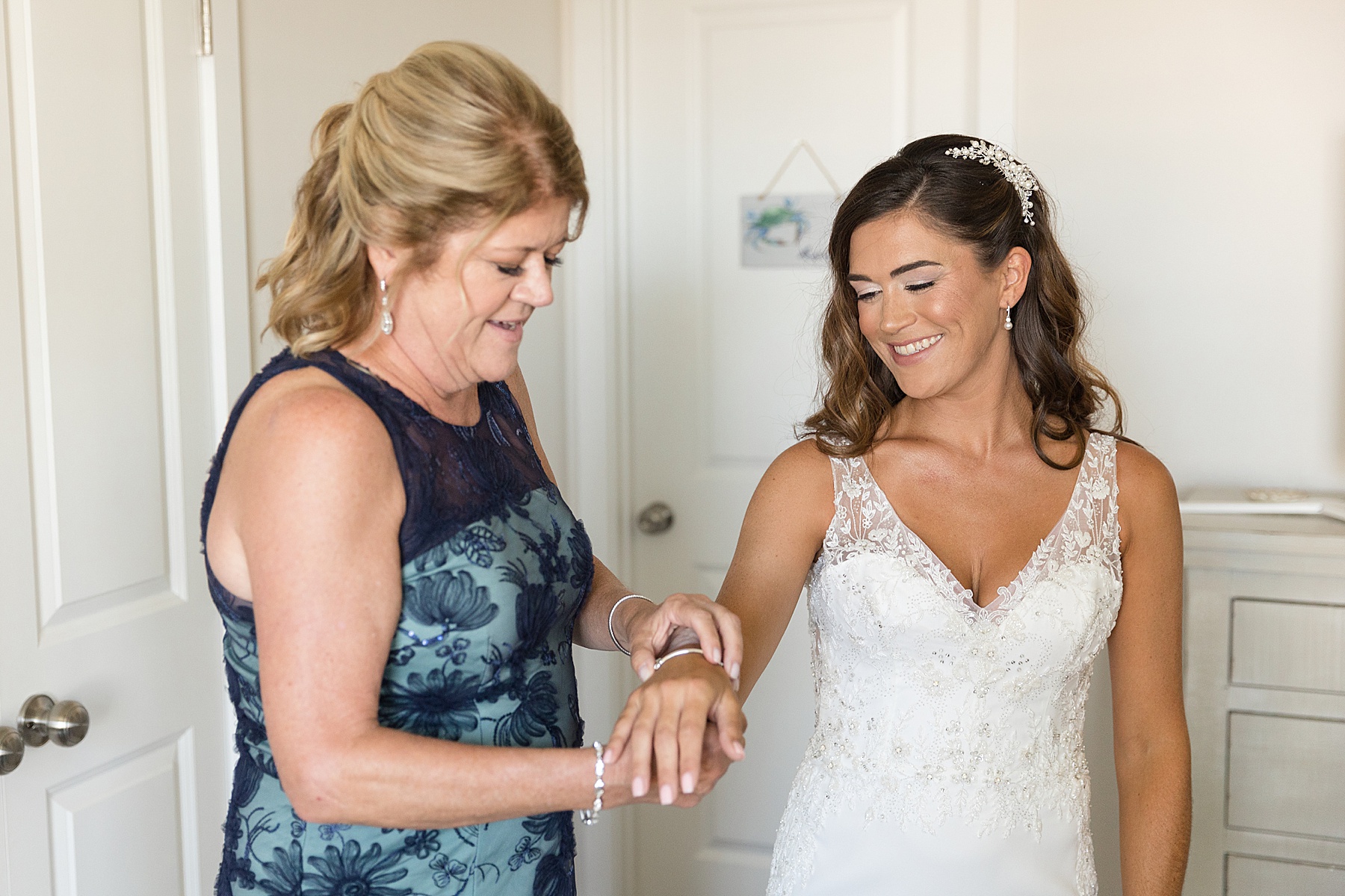 bride gets dressed with mom