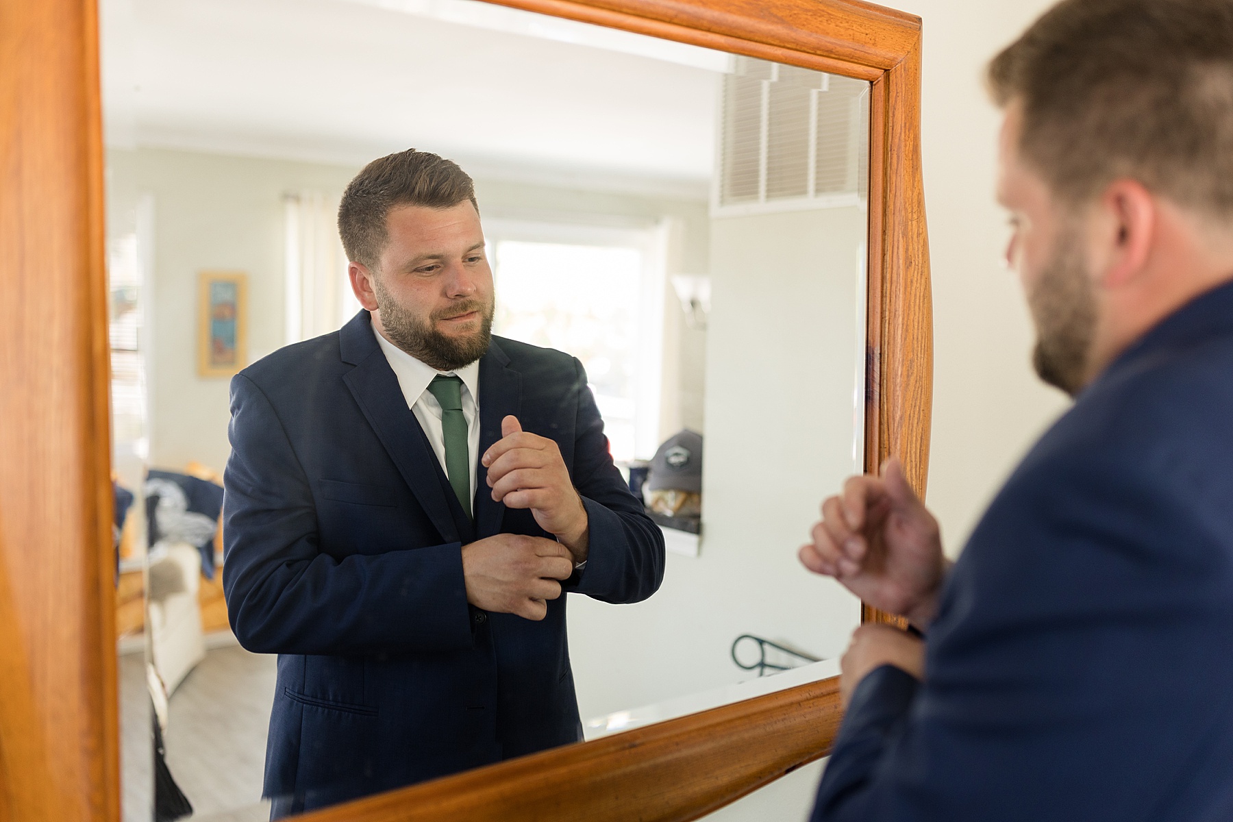 groom in mirror getting ready