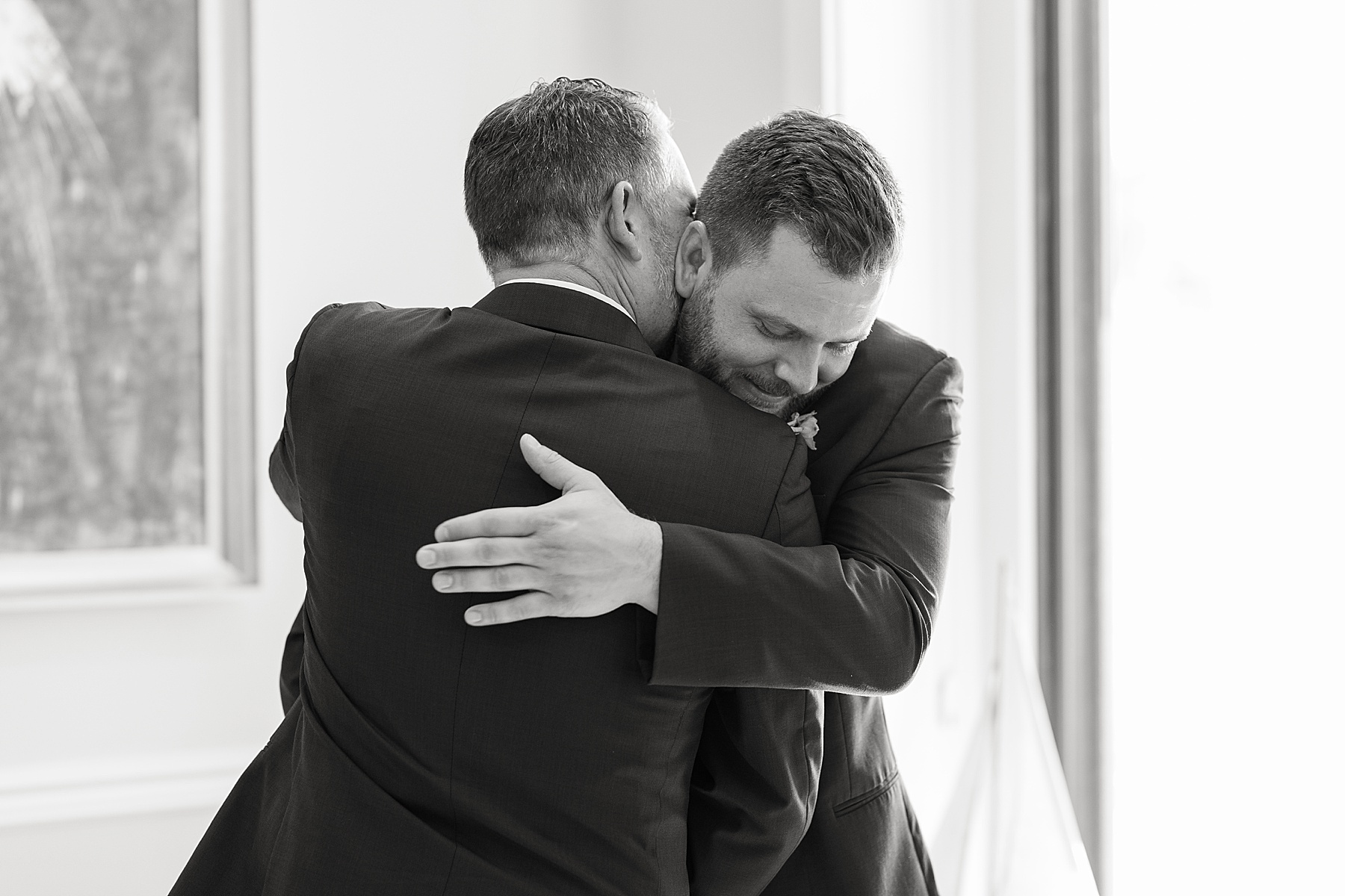 groom hugging groosmen