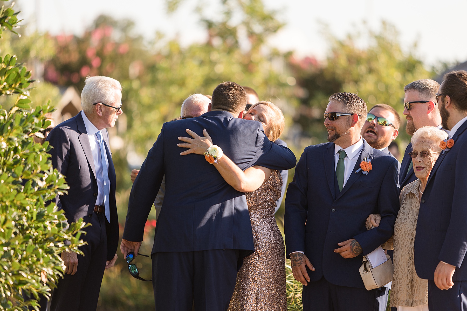 groom hugging parents