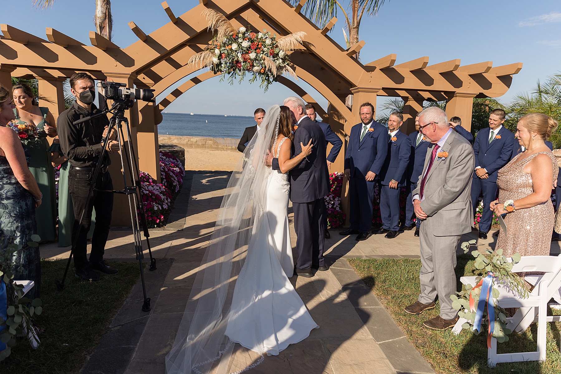 bride hugging dad at end of aisle