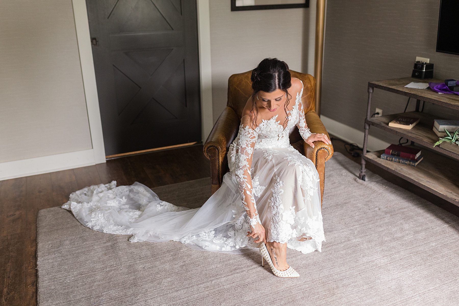 bride putting shoes on