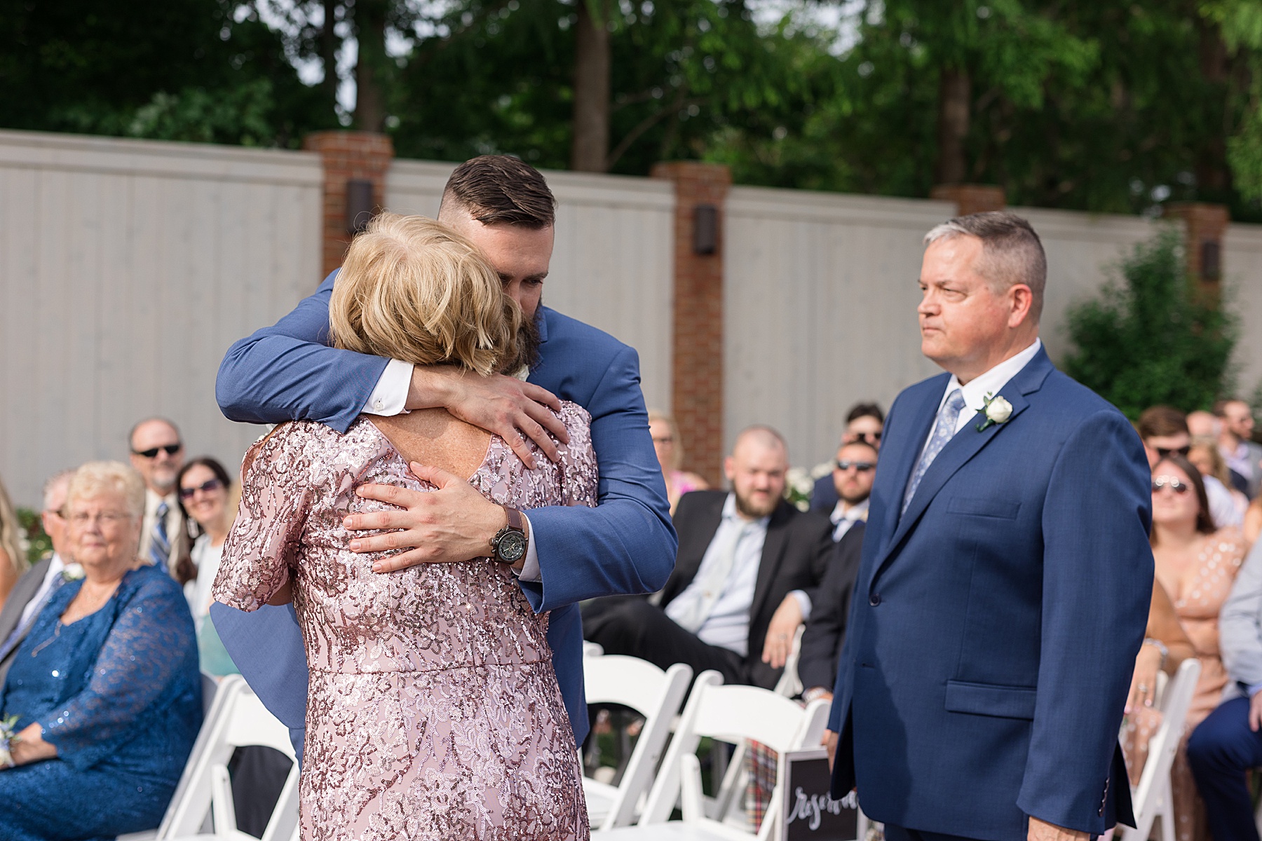 groom hugging parents after precessional