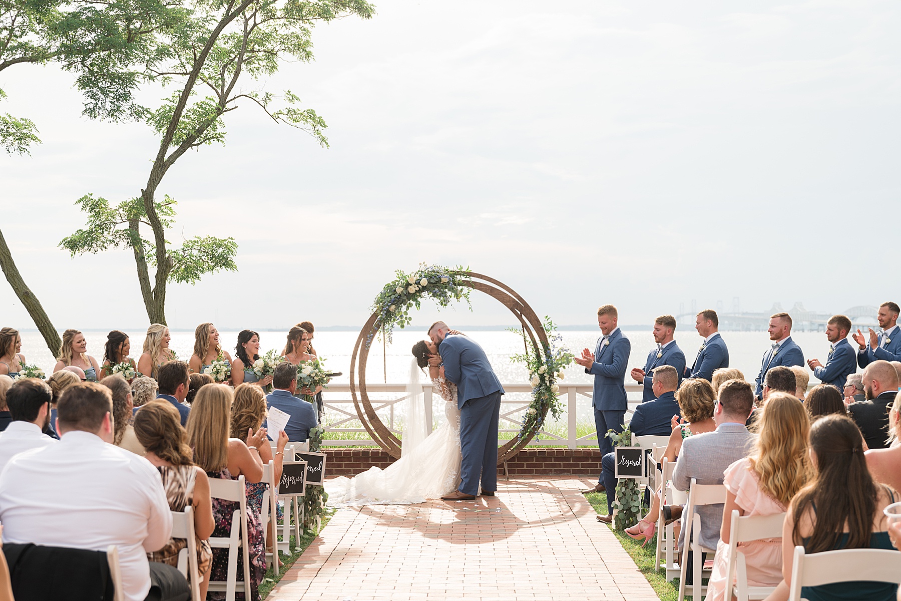 chesapake bay beach club outdoor wedding first kiss