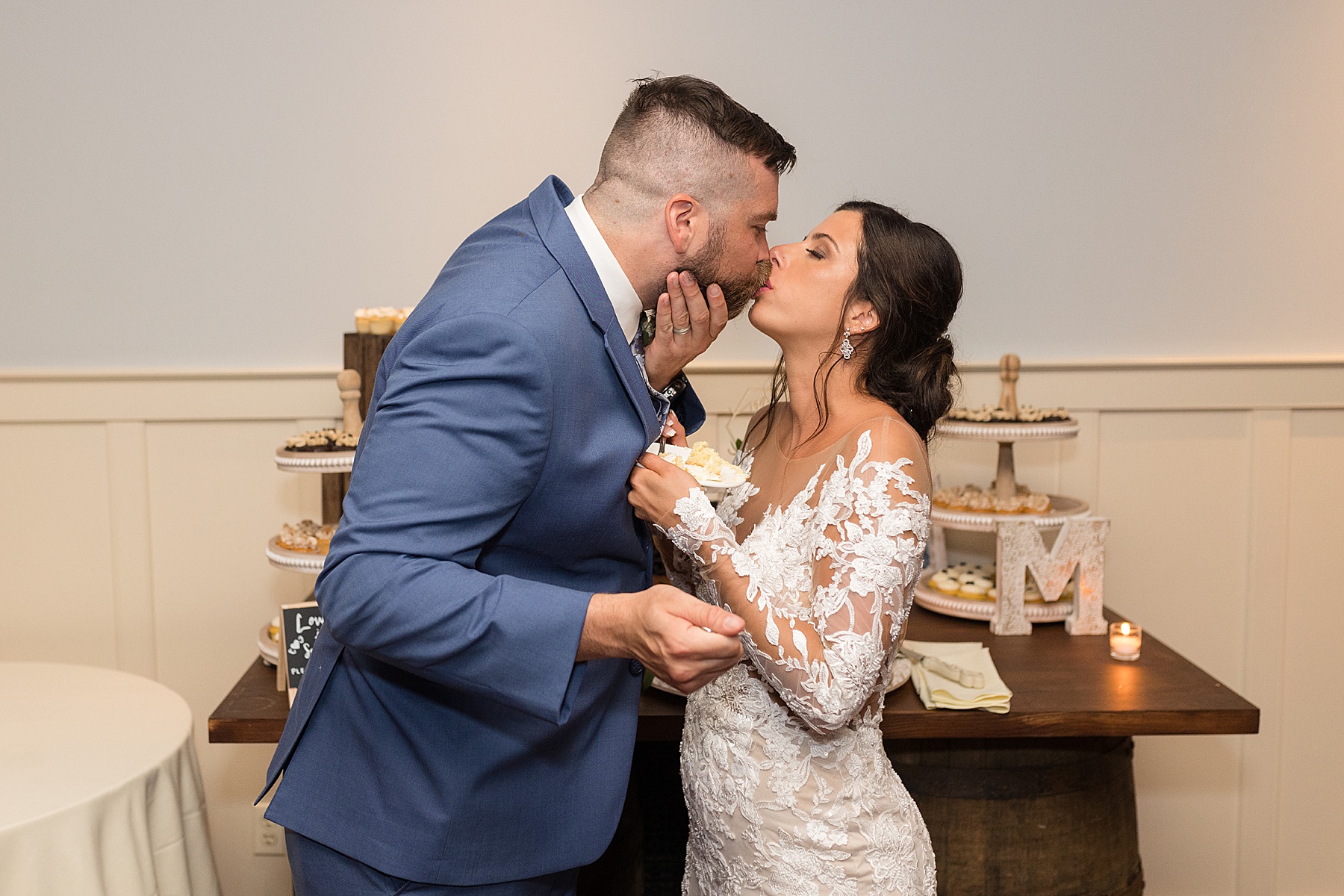 bride and groom kiss after cake cutting