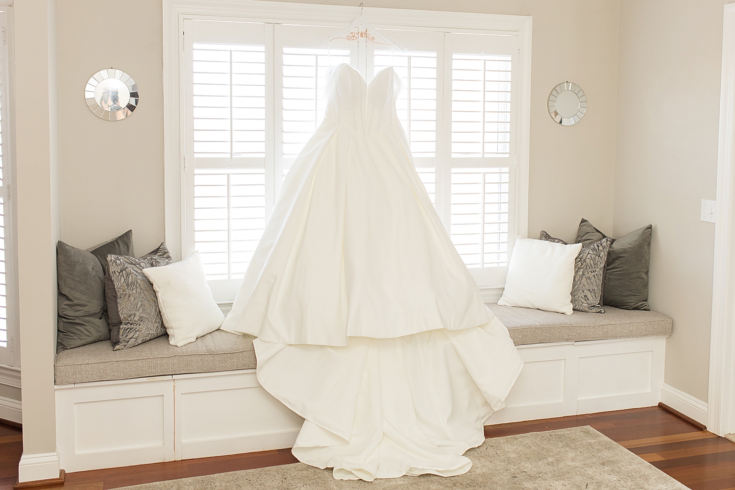 wedding dress hanging from window