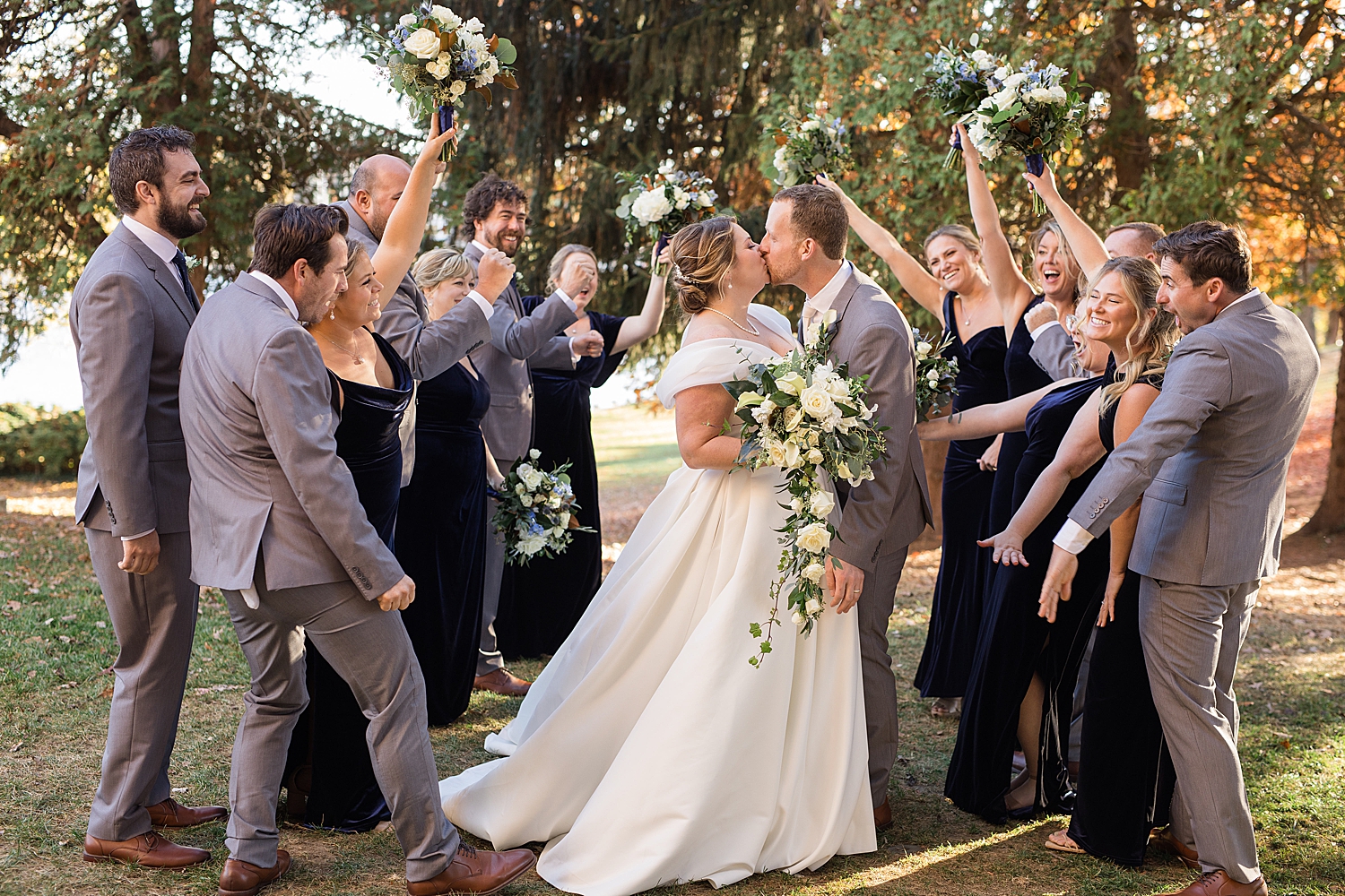 newlyweds with full wedding party tunnel cheering