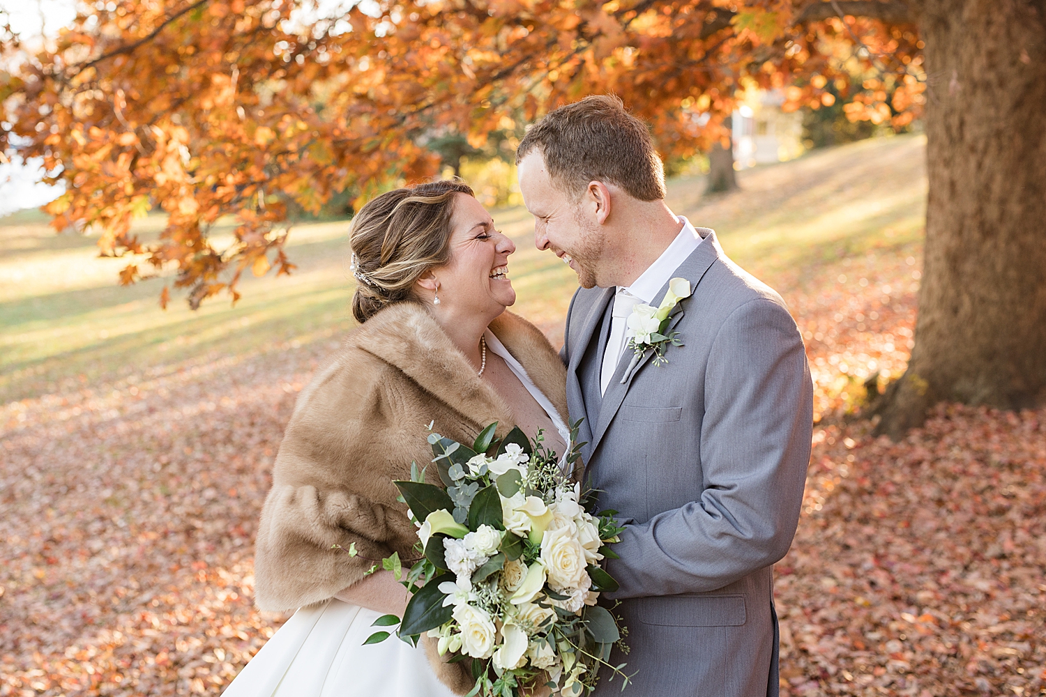 couple portrait november foliage smiling at each other