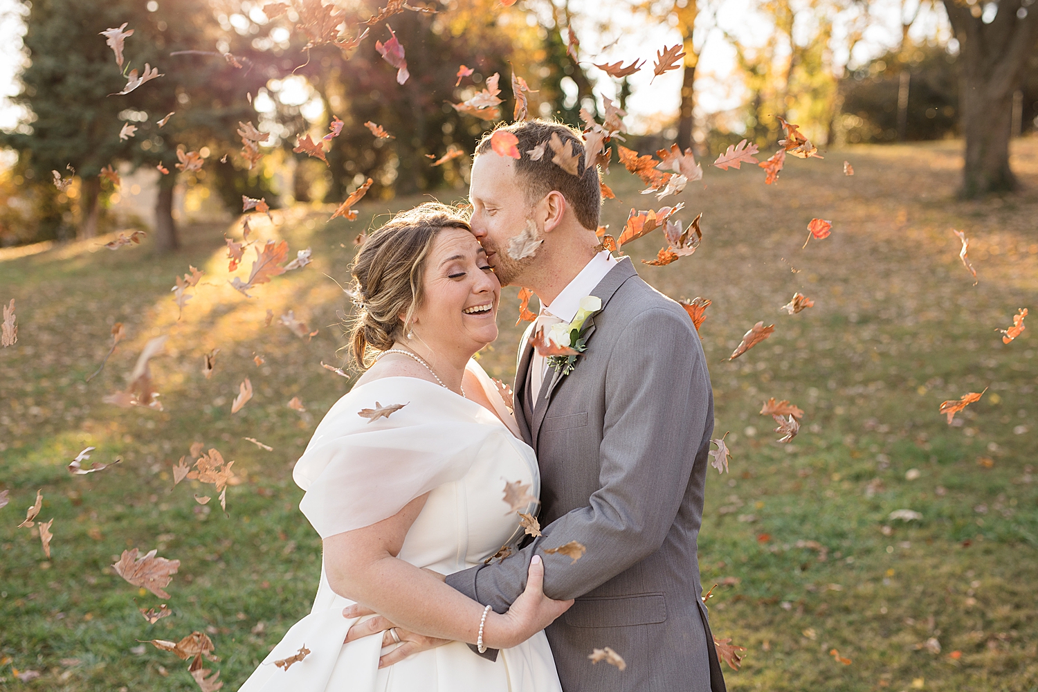 bride and groom couple portrait laughing fall leaves