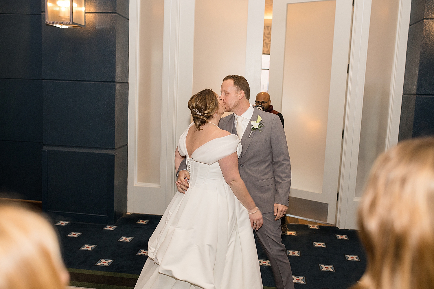 bride and groom enter reception kiss