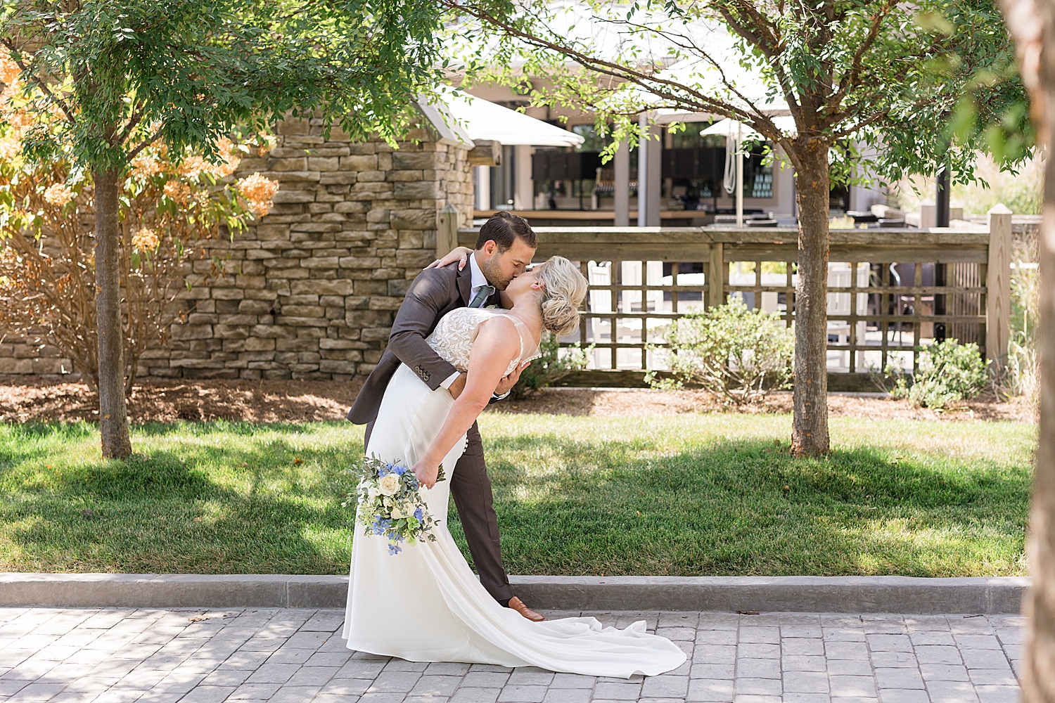 bride and groom portrait dip kiss