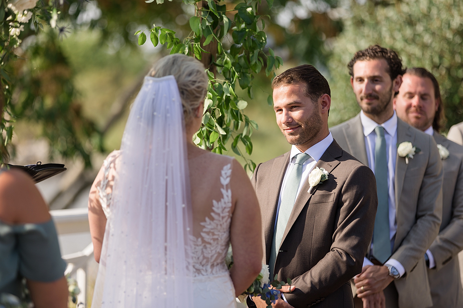 groom looks at bride during ceremony