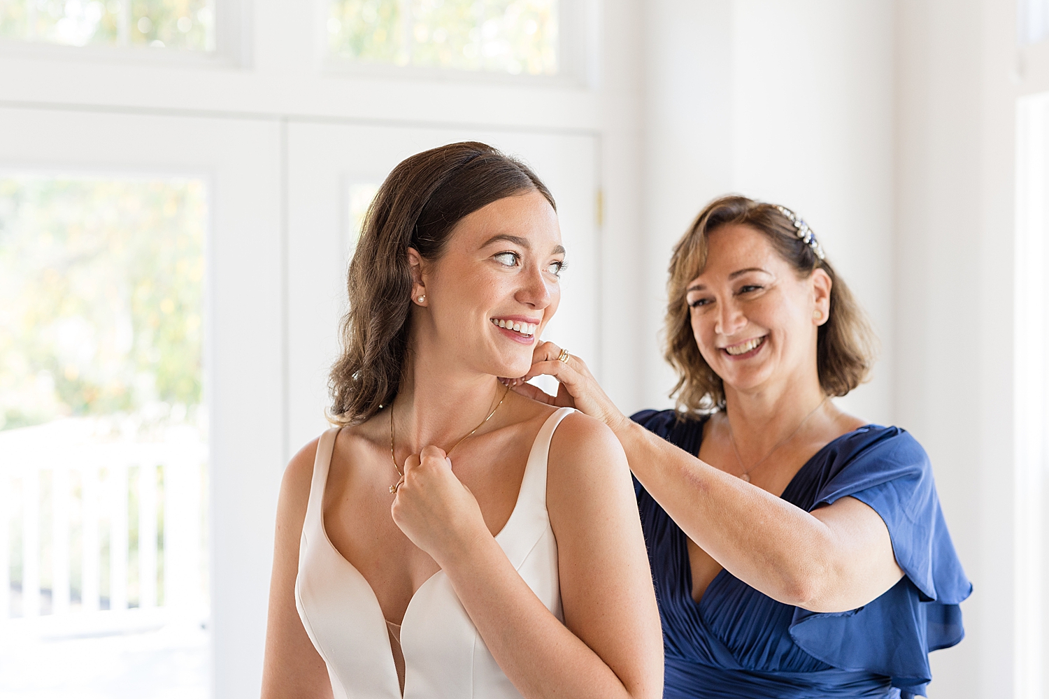 bride and her mom getting ready necklace