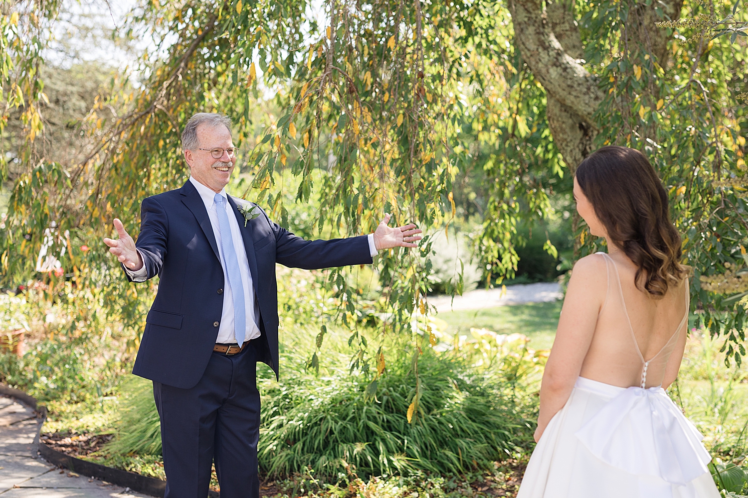 bride first look with dad hug