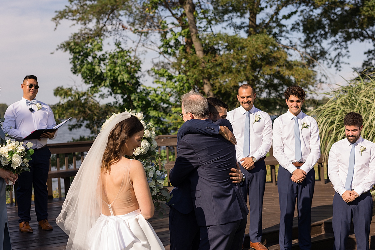 dad giving away bride hugging groom